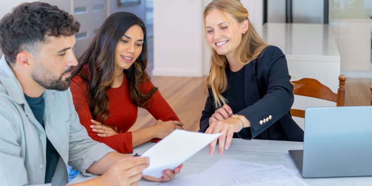 Family Signs Loans Documents at Table