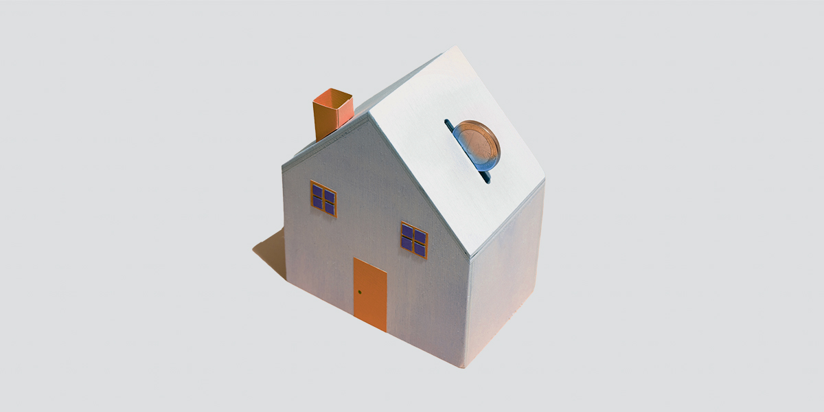 House-shaped piggy bank with coin.