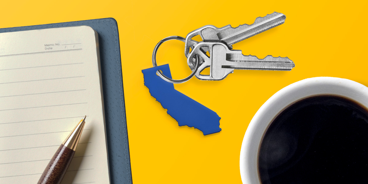 image of keychain with a map of California and 2 keys next to a cup of coffee and a notebook with a pen
