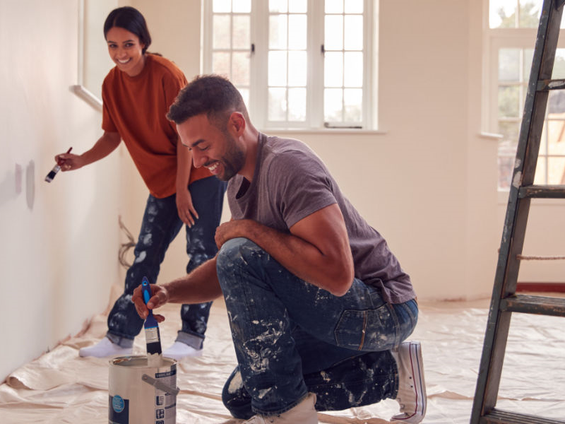 Couple painting a home